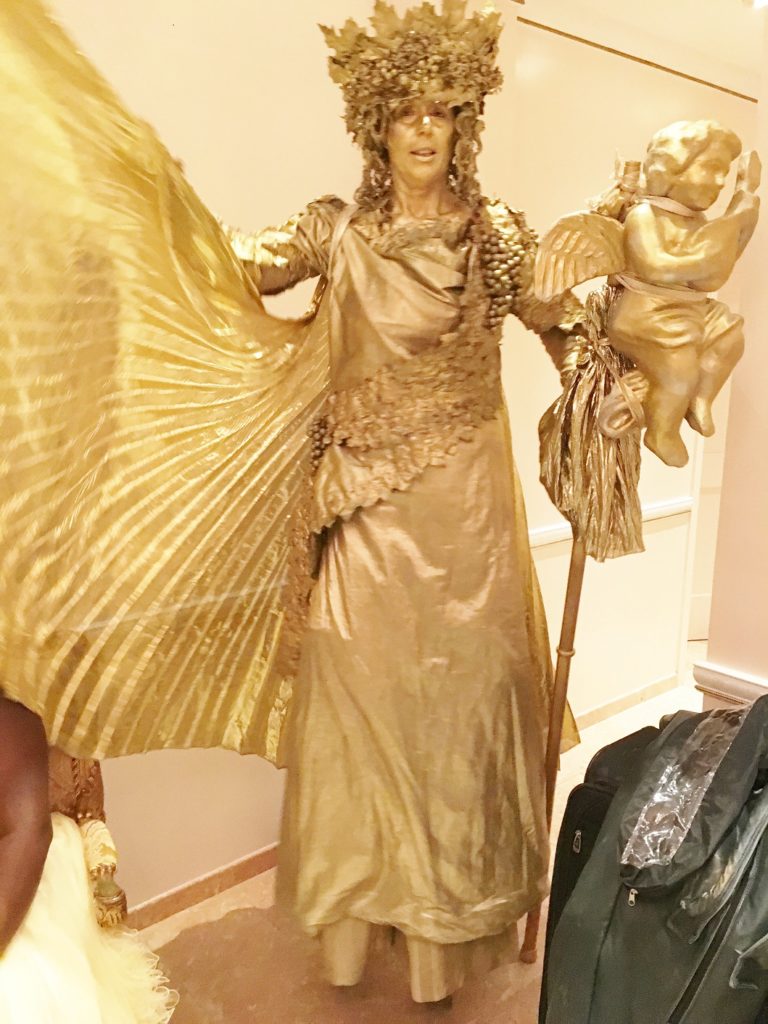 Penny England as Golden Goddess Statue on Stilts